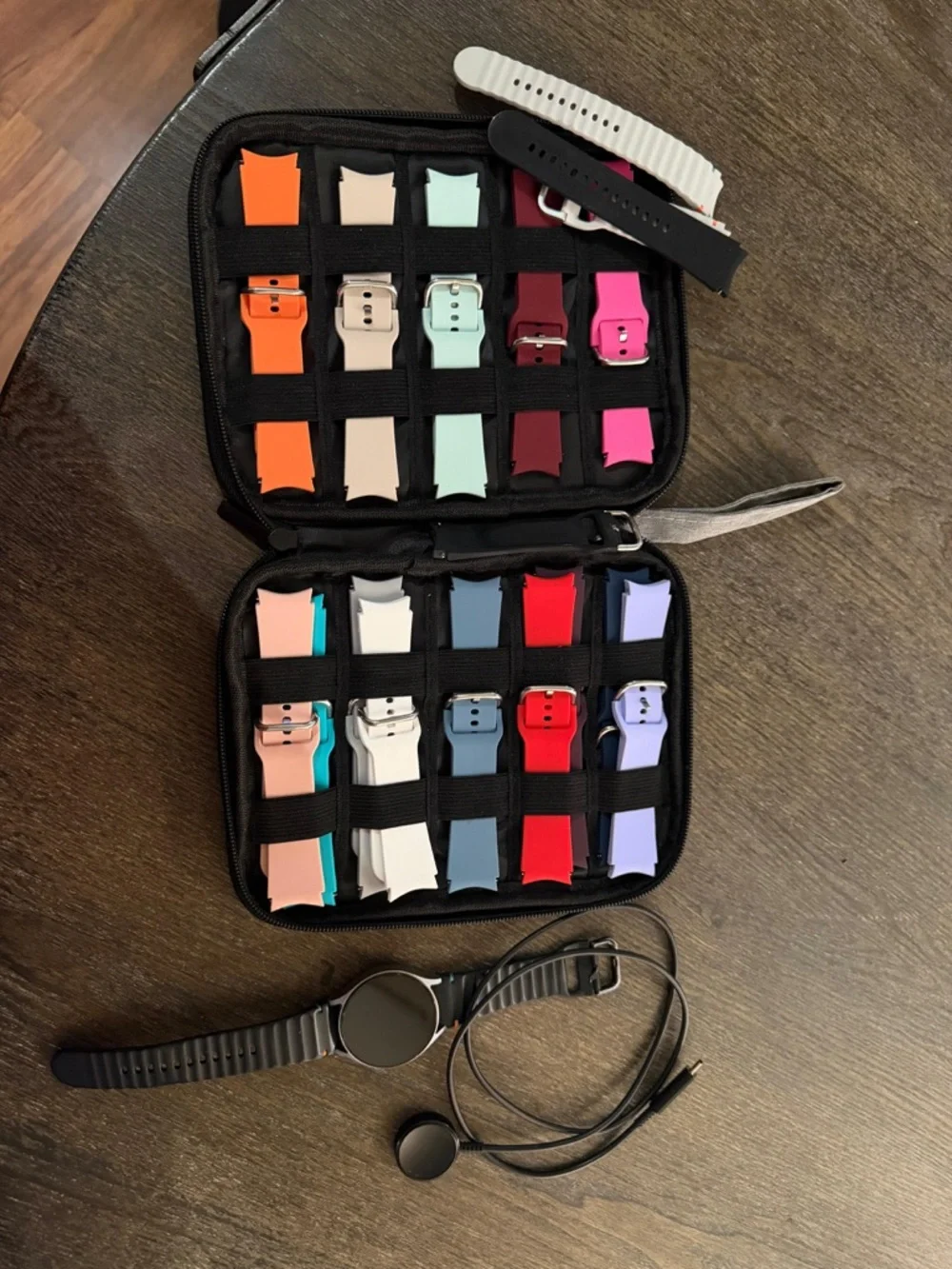Samsung smartwatch with multiple colorful silicone bands